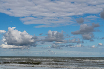 View of the stormy Baltic Sea against a cloudy sky on a sunny summer day, Curonian Spit, Kaliningrad region, Russia