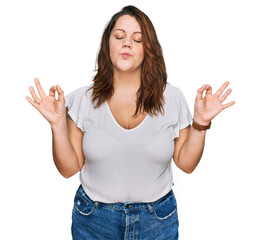 Young plus size woman wearing casual white t shirt relaxed and smiling with eyes closed doing meditation gesture with fingers. yoga concept.