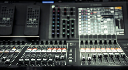 Professional audio studio sound mixer console board panel with recording , faders and adjusting...