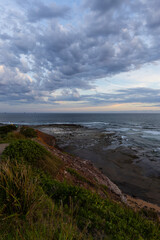 Fototapeta na wymiar Cloudy sunset view at Long Reef headland, Sydney, Australia.