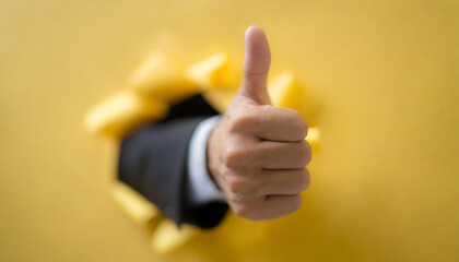 Businessman hand thumb up from yellow punched paper for client the best satisfaction evaluation survey after use product and service concept.