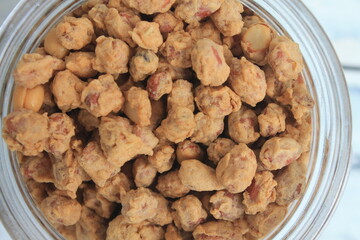 Indonesian snack called fried peanuts in a jar on the table