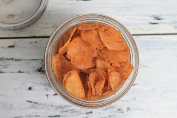 Indonesian snack called spicy chips in a jar on the table