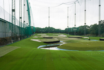 Golf driving range made of large green wire mesh