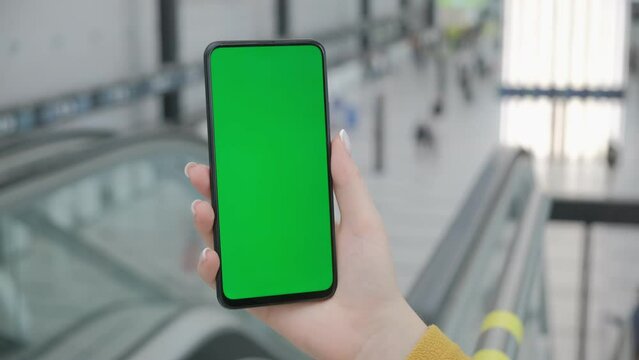 Airport Terminal: Businesswoman Working on Green Chroma Key Screen Mobile Smartphone, Waits for a Plane Flight. Female Does Online Remote Work in Boarding Lounge of Airline Hub.