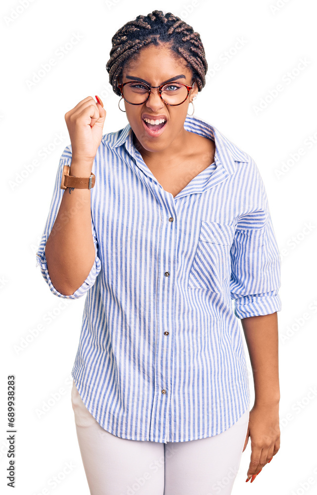 Canvas Prints Young african american woman with braids wearing casual clothes and glasses angry and mad raising fist frustrated and furious while shouting with anger. rage and aggressive concept.