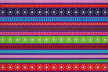 White snowflakes and geometric patterns on a multicolored background wrapping paper. Christmas Holiday concept.