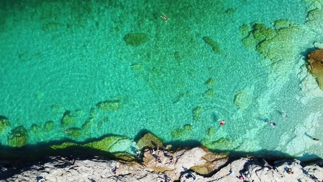 Top View Of Tourists Swimming On Turquoise Beach Of Flowerpot Island, Georgian Bay, Ontario, Canada. Aerial Shot