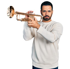 Young hispanic man with beard playing trumpet skeptic and nervous, frowning upset because of problem. negative person.
