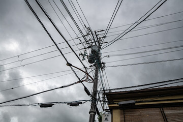 Power lines and transistors on an electricity pilon in Kyoto, Japan
