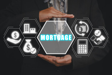 Mortgage concept, Business woman hand holding mortgage icon on virtual screen, mortgage and real estate investment.to buy a house.