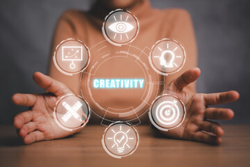 Fototapeta na wymiar Creativity concept, Business person hand holding creativity icon on virtual screen.