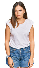 Fototapeta premium Young caucasian woman wearing casual white tshirt skeptic and nervous, frowning upset because of problem. negative person.