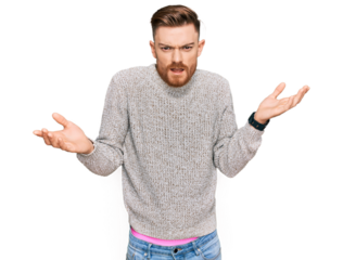 Young redhead man wearing casual winter sweater clueless and confused with open arms, no idea concept.