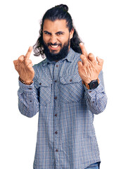 Young arab man wearing casual clothes showing middle finger doing fuck you bad expression,...
