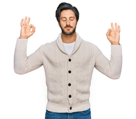 Young hispanic man wearing casual clothes relax and smiling with eyes closed doing meditation gesture with fingers. yoga concept.