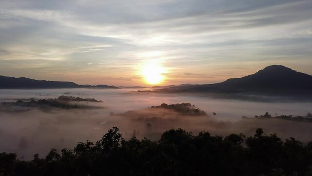 Sunrise at Khao Takhian Ngo. Morning landscape of mist and beautiful sunrise. Time lapse video.