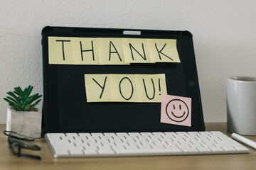Sticky notes with Thank You text on computer screen.