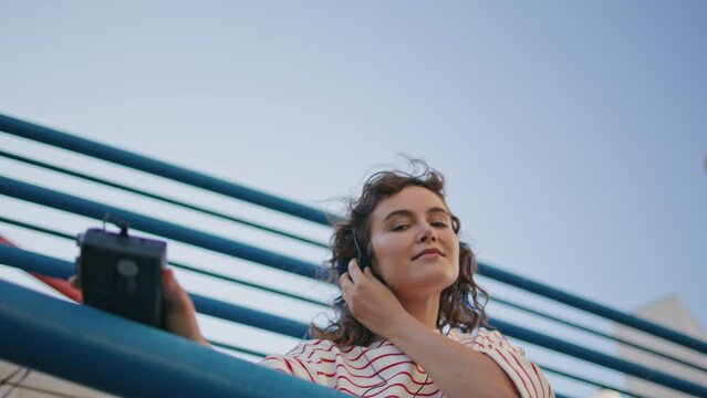 Headphone woman moving tact rhythmic music at street close up. Girl listening
