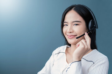 Portrait of attractive trendy cheerful asian woman girl help desk service showing copy space isolated over blue color background. Asian service girl call center.