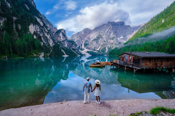A couple of men and women at Lago Di Braies or Pragser Wildsee Italy South Tyrol, Beautiful emerald...