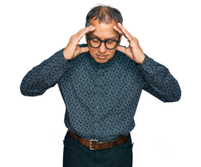 Middle age indian man wearing casual clothes and glasses with hand on head for pain in head because stress. suffering migraine.