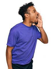 Young african american man with beard wearing casual purple t shirt shouting and screaming loud to side with hand on mouth. communication concept.