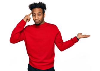 Young african american man with beard wearing casual winter sweater confused and annoyed with open palm showing copy space and pointing finger to forehead. think about it.