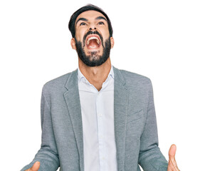 Young hispanic man wearing business clothes angry and mad screaming frustrated and furious, shouting with anger. rage and aggressive concept. - obrazy, fototapety, plakaty