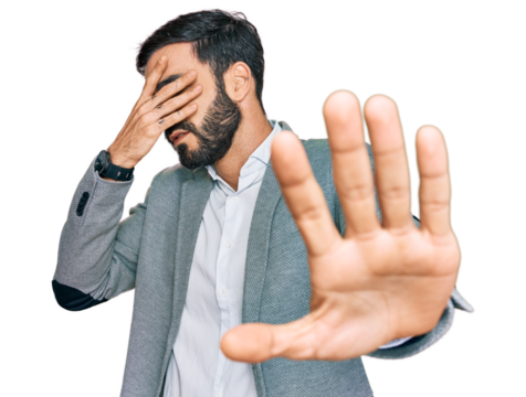 Young hispanic man wearing business clothes covering eyes with hands and doing stop gesture with sad and fear expression. embarrassed and negative concept.