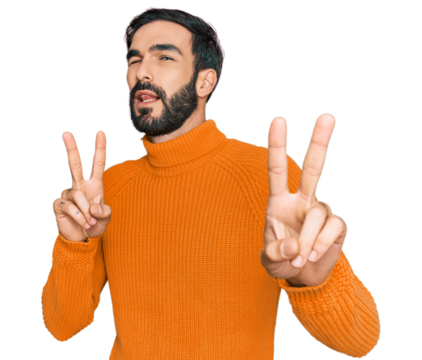 Young hispanic man wearing casual clothes smiling looking to the camera showing fingers doing victory sign. number two.
