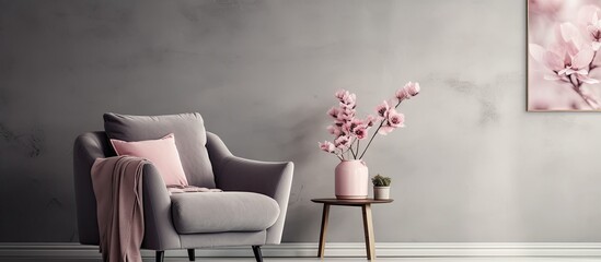 Real photo of flowers behind armchair in grey living room with poster.