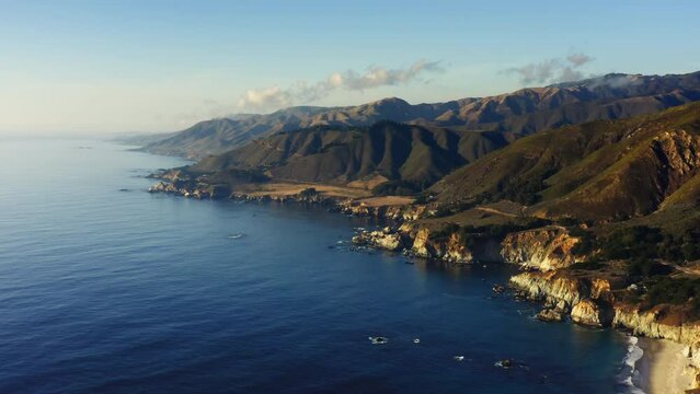 4k aerial drone footage California road to San Francisco. Spectacular view on the blue ocean on the sunset. Mountain Along Pacific Coast in Monterey. Big Sur. USA