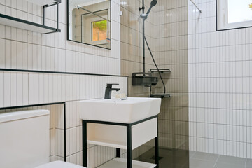 A minimalist bathroom has a black and white concept