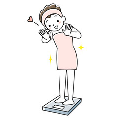 体重計に乗って喜ぶ若い女性