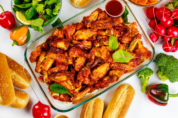Buffalo chicken wings with dip sauce and vegetable salad.