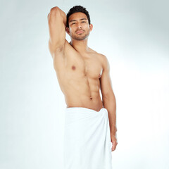 Shower, towel and portrait of asian man body in studio for wellness, cosmetics or cleaning on white...