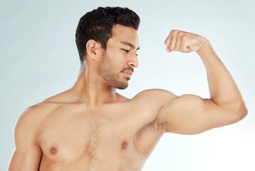 Fitness, bicep flex and asian man in studio for wellness, training or workout results on white background. Body, exercise and Japanese male model with strong arm pose for strength or muscle growth