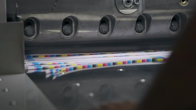 mechanized guillotine cutting a pile of paper slow motion