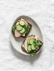 Delicious breakfast, snack, tapas - rye bread sandwiches with baked turkey, cucumber and cottage...