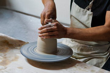 Fototapeta na wymiar A clay craftsman shapes a ceramic item on a potter's wheel, Türkiye