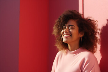 Portrait of a full-bodied woman smiling, wearing pink clothing in front of a pink background
