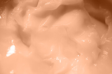 Beauty cream texture. Creamy skincare product closeup. Color peach fuzz.