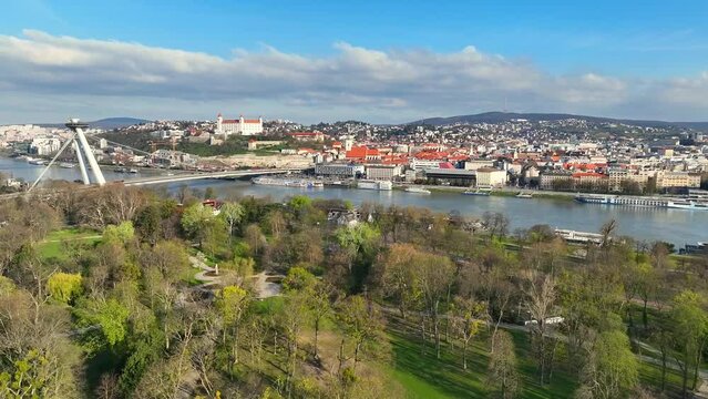 Spring in Bratislava, Slovakia. Green Trees in Janko Kral Park on Sunny Day. Bratislava Old Town and Castle Cityscape. - Arial drone view