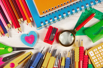 School supplies are laid out in a composition on a light background. Back to school.