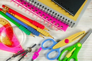 School supplies are laid out in a composition on a light background. Back to school.