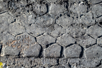 tire tracks in the mud on the ground
