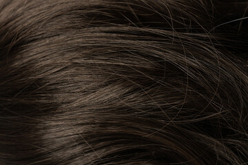 Dark long hair in close-up. A wave of hair as a background
