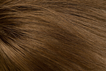 Dark long hair in close-up. A wave of hair as a background