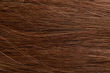 Dark long hair in close-up. A wave of hair as a background